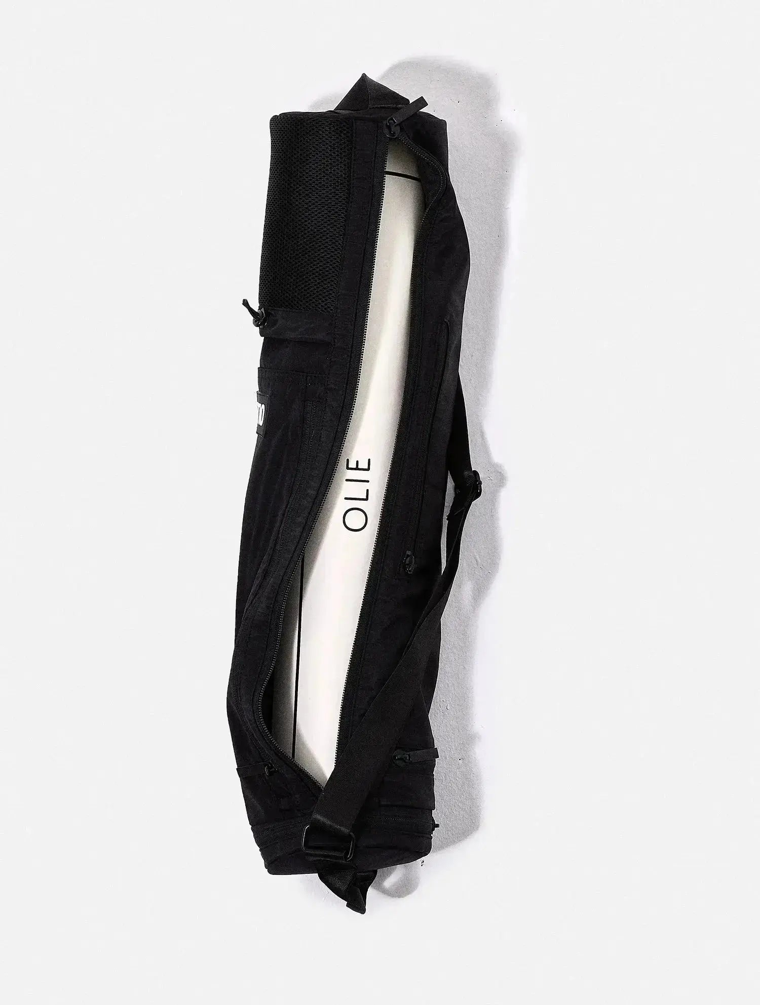 The OLIE BLACK YOGA MAT BAG. Made From 100% Recycled Materials. An Enhanced Take On The Classic Yoga Mat Bag.